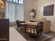 Comfortable home office with modern desk, chairs, and ample natural light from a large window at 8 E Biltmore Est # 109, Phoenix, AZ 85016
