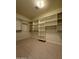 Large walk-in closet with carpet flooring and installed shelving, offering ample storage at 8 E Biltmore Est # 109, Phoenix, AZ 85016