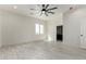 Bright bedroom with a ceiling fan and an ensuite bathroom entrance at 22205 W Ocupado Dr, Wittmann, AZ 85361