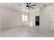 Neutral bedroom featuring ceramic tile flooring, white walls, ceiling fan and a window at 22205 W Ocupado Dr, Wittmann, AZ 85361