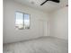 Bright bedroom with a large window and closet with sliding doors at 22205 W Ocupado Dr, Wittmann, AZ 85361