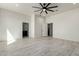 Open layout bedroom with multiple access doors to bathrooms and walk-in closets at 22205 W Ocupado Dr, Wittmann, AZ 85361
