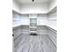 Walk-in closet with built-in shelving and wood-style tile flooring at 22205 W Ocupado Dr, Wittmann, AZ 85361