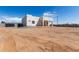 New construction single-Gathering home with a modern design and ample land, set against a clear blue sky at 22205 W Ocupado Dr, Wittmann, AZ 85361