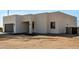 Close angle of modern single-Gathering home, featuring garage and xeriscaped front yard ready for landscaping and design at 22205 W Ocupado Dr, Wittmann, AZ 85361