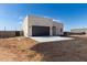 Exterior view of a contemporary single-Gathering home, showing the garage and a spacious lot under a blue sky at 22205 W Ocupado Dr, Wittmann, AZ 85361