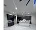 Spacious kitchen area with dark cabinetry and a central island with white countertop at 22205 W Ocupado Dr, Wittmann, AZ 85361