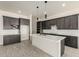 Kitchen with gray cabinets, white quartz countertops and stainless steel appliances at 22205 W Ocupado Dr, Wittmann, AZ 85361