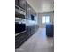 Modern kitchen features sleek dark cabinets, stainless steel appliances, and light countertops at 22205 W Ocupado Dr, Wittmann, AZ 85361