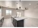 Kitchen island with pendant lights and a sink with stainless steel appliances at 22205 W Ocupado Dr, Wittmann, AZ 85361