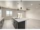 Kitchen island with pendant lights and a sink with stainless steel appliances at 22205 W Ocupado Dr, Wittmann, AZ 85361