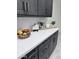 Clean white kitchen countertop with decor, dark cabinets, and tiled backsplash at 22205 W Ocupado Dr, Wittmann, AZ 85361