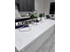 Bright kitchen island with white countertop and stainless steel faucet fixtures at 22205 W Ocupado Dr, Wittmann, AZ 85361