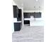 Open-concept kitchen with dark cabinets, a large island, and wood-style tile flooring at 22205 W Ocupado Dr, Wittmann, AZ 85361
