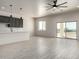 Spacious living room with gray ceramic tile flooring and sliding glass doors to back patio at 22205 W Ocupado Dr, Wittmann, AZ 85361