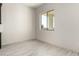 Neutral living room features ceramic tile flooring, white walls and a large window at 22205 W Ocupado Dr, Wittmann, AZ 85361