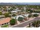 Aerial view of home with surrounding neighborhood and mountains at 8044 E Del Mercurio Dr, Scottsdale, AZ 85258