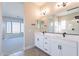 Modern bathroom with double vanity, large mirror, and shower at 20252 W Catalina Dr, Buckeye, AZ 85396