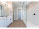Modern bathroom boasts double vanity, frameless shower, and tile floor at 20252 W Catalina Dr, Buckeye, AZ 85396