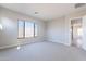 Well-lit bedroom featuring carpet flooring and a window at 20252 W Catalina Dr, Buckeye, AZ 85396
