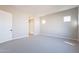 Comfortable bedroom with carpet, door to bathroom, and window at 20252 W Catalina Dr, Buckeye, AZ 85396