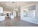 Kitchen opens to dining area with large window and chandelier at 20252 W Catalina Dr, Buckeye, AZ 85396