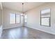 Light-filled dining area with tile floors and elegant chandelier at 20252 W Catalina Dr, Buckeye, AZ 85396