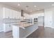 Modern kitchen with white cabinets, a large island, and stainless steel appliances at 20252 W Catalina Dr, Buckeye, AZ 85396