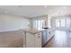 Modern kitchen with island, white cabinets, and open floor plan at 20252 W Catalina Dr, Buckeye, AZ 85396