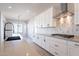 Bright kitchen boasts white cabinets, center island, and stylish fixtures at 20252 W Catalina Dr, Buckeye, AZ 85396