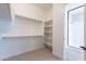 Bright walk-in closet, built-in shelves, and hanging space at 20252 W Catalina Dr, Buckeye, AZ 85396