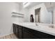 Bathroom with dark vanity, mirror, and shelves at 130 N Bay Dr, Gilbert, AZ 85233