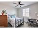 Bedroom featuring a bed, desk, and ceiling fan at 130 N Bay Dr, Gilbert, AZ 85233