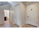 Bright entry hall with tile floors, powder room, and coat closet at 130 N Bay Dr, Gilbert, AZ 85233