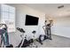 Upper level home gym with stationary bike, elliptical, and TV at 130 N Bay Dr, Gilbert, AZ 85233