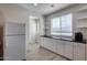 White kitchen cabinets and a modern refrigerator at 130 N Bay Dr, Gilbert, AZ 85233