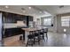 Modern kitchen with granite island, dark cabinetry, and tile flooring at 130 N Bay Dr, Gilbert, AZ 85233