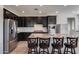 Modern kitchen with dark cabinetry, granite countertops, and stainless steel appliances at 130 N Bay Dr, Gilbert, AZ 85233