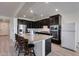 Spacious kitchen with dark cabinetry and granite countertops at 130 N Bay Dr, Gilbert, AZ 85233