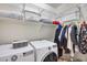 Laundry room with washer, dryer, and shelving at 130 N Bay Dr, Gilbert, AZ 85233