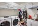 Laundry room with washer, dryer, and shelving at 130 N Bay Dr, Gilbert, AZ 85233