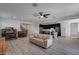 Spacious living room with tile floors, light walls, and a tan couch at 130 N Bay Dr, Gilbert, AZ 85233