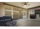 Covered patio with seating area and sliding glass doors leading to the pool at 130 N Bay Dr, Gilbert, AZ 85233