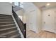 Modern staircase with dark wood railing leading to the second floor at 130 N Bay Dr, Gilbert, AZ 85233