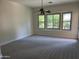 Well-lit bedroom with bay window and ceiling fan at 1187 E Tonto Dr, Chandler, AZ 85249