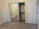 Mirrored closet doors and shelving in bedroom closet at 1187 E Tonto Dr, Chandler, AZ 85249