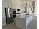 Modern kitchen with white cabinets, quartz countertops, and a large island at 1187 E Tonto Dr, Chandler, AZ 85249