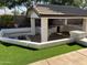 Covered patio with outdoor kitchen and fire pit at 1187 E Tonto Dr, Chandler, AZ 85249