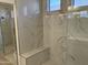 Walk-in shower with marble-look tile and built-in seat at 1187 E Tonto Dr, Chandler, AZ 85249