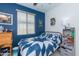 Spacious bedroom with blue walls, a full-size bed, and ample storage at 21667 S 225Th Way, Queen Creek, AZ 85142